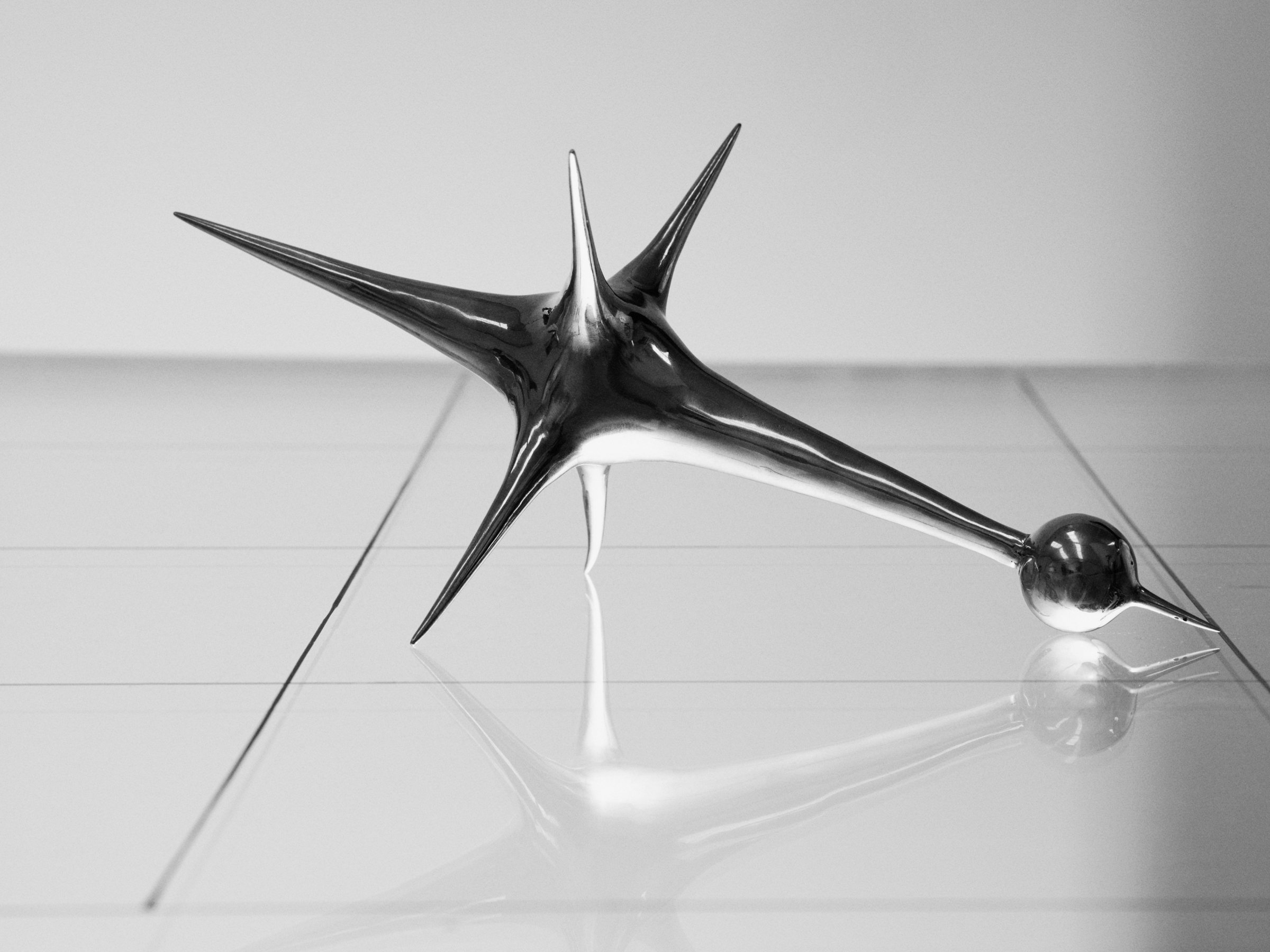 Harmonic Oscillators, art by Pilar Zeta, bronze resting pendulum sculpture photographed for L'Officiel Ibiza, 2026. Photo: Txema Yeste