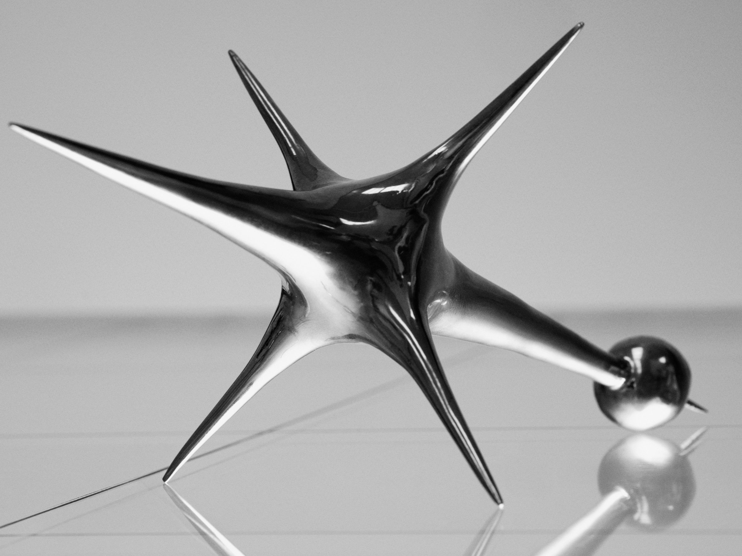 Harmonic Oscillators, art by Pilar Zeta, bronze resting pendulum sculpture photographed for L'Officiel Ibiza, 2026. Photo: Txema Yeste